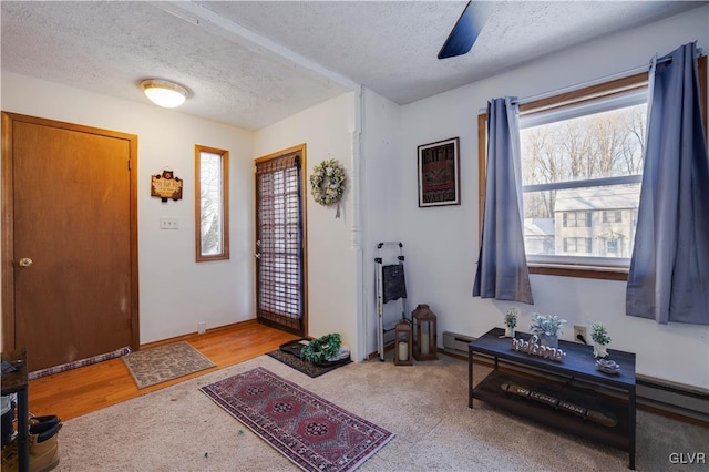 entryway featuring a baseboard radiator and a textured ceiling