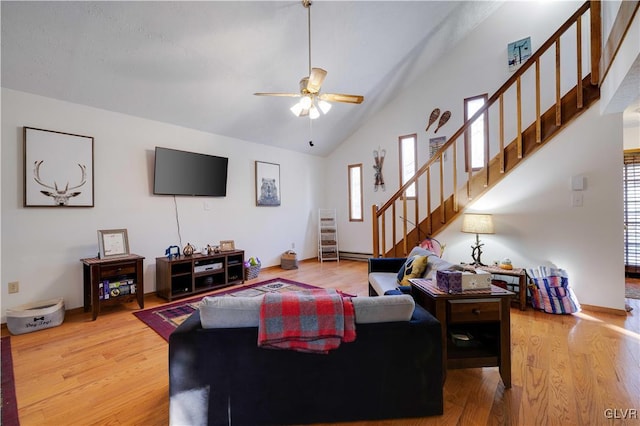 living room with wood-type flooring, high vaulted ceiling, and ceiling fan