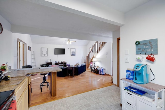 interior space with ceiling fan, stainless steel range with electric cooktop, and light hardwood / wood-style floors