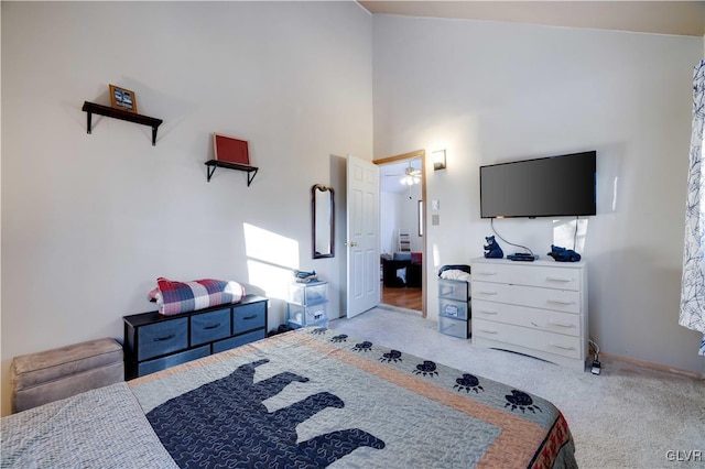 bedroom with light colored carpet and a high ceiling