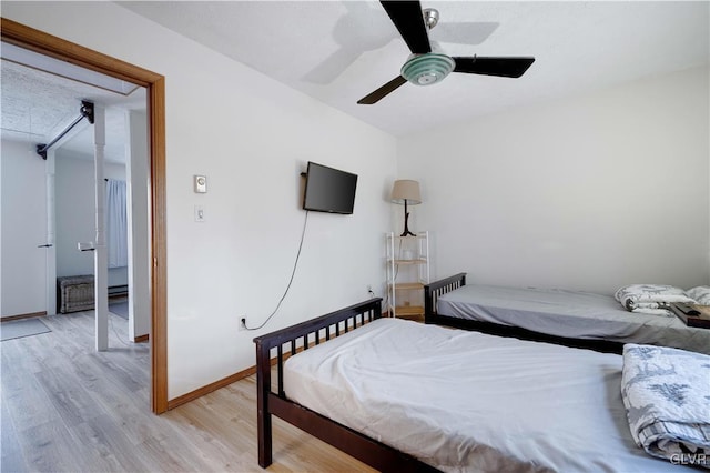 bedroom with ceiling fan and light wood-type flooring