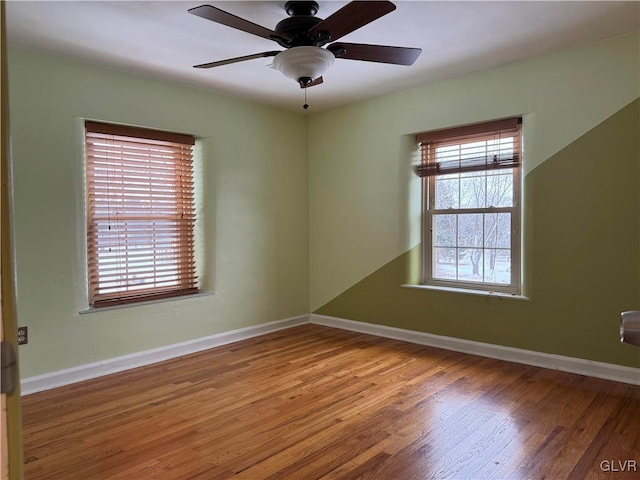 unfurnished room with hardwood / wood-style floors and ceiling fan