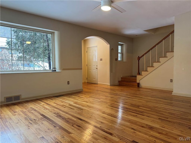 foyer featuring ceiling fan, a wealth of natural light, and light wood-type flooring