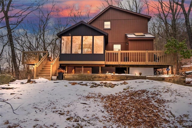 view of front of property featuring a sunroom and a deck