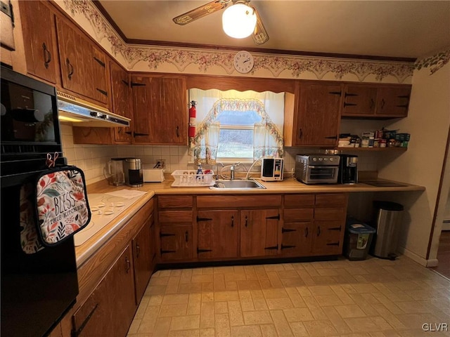 kitchen with sink, extractor fan, tasteful backsplash, ceiling fan, and crown molding