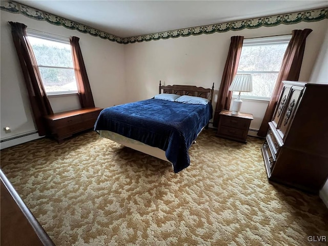 bedroom featuring multiple windows, carpet floors, and a baseboard radiator