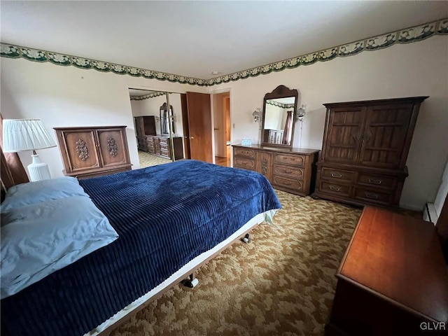 carpeted bedroom featuring a baseboard heating unit