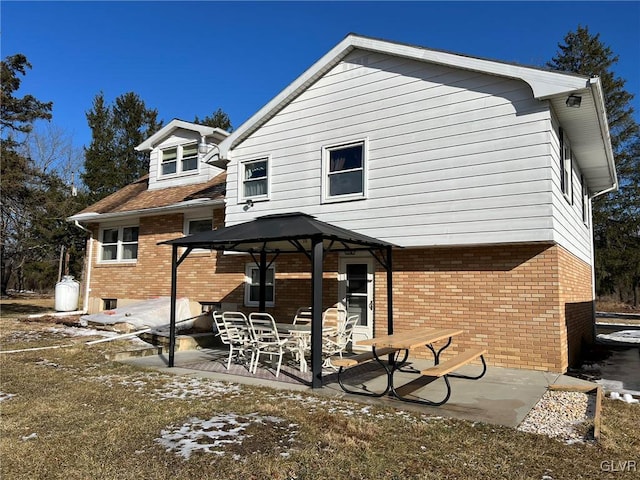 rear view of house with a patio and a gazebo