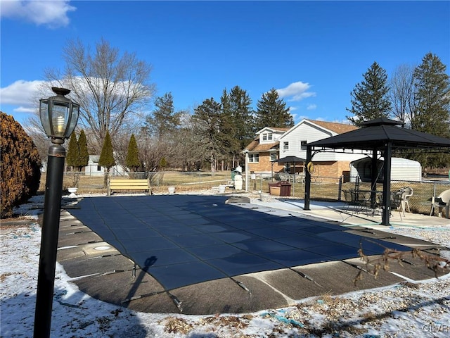 snow covered pool with a patio and a gazebo