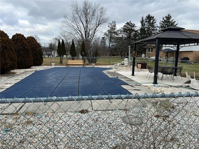 view of swimming pool featuring a gazebo and a patio area