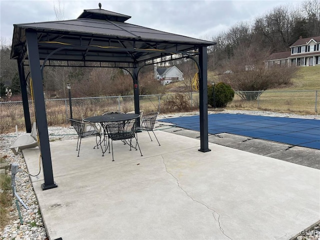 view of patio / terrace with a covered pool and a gazebo