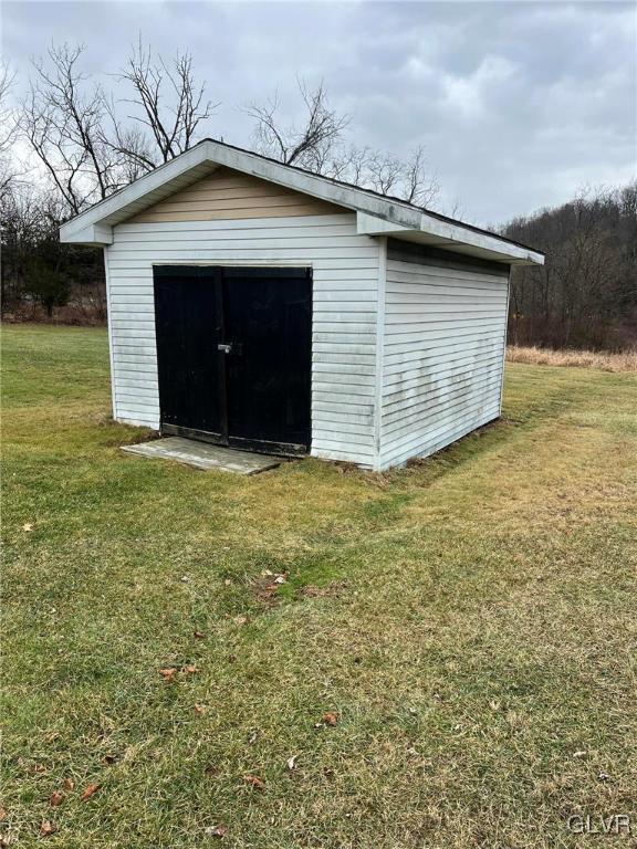 view of outbuilding with a lawn