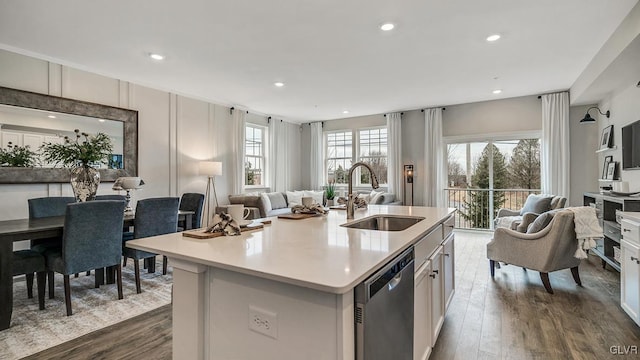 kitchen featuring sink, white cabinetry, a center island with sink, dark hardwood / wood-style flooring, and dishwasher