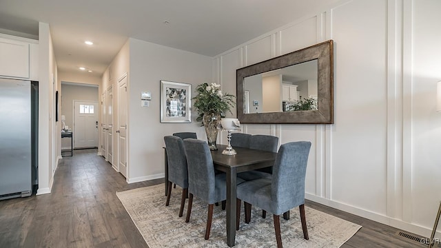 dining area with dark hardwood / wood-style floors