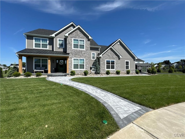 view of front of property with a standing seam roof, metal roof, board and batten siding, and a front yard