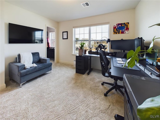 carpeted home office featuring visible vents and baseboards