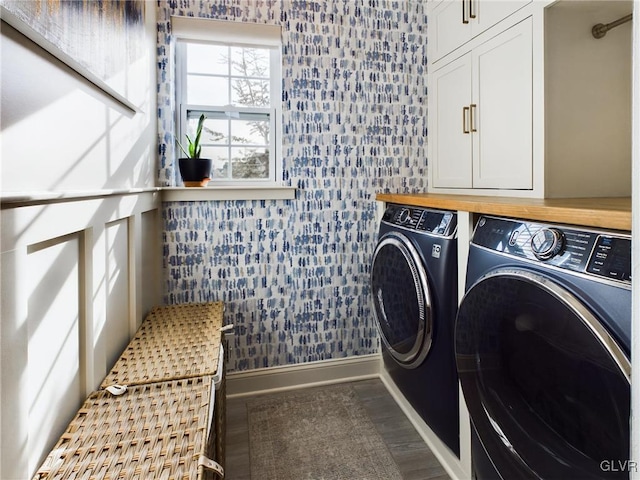 washroom with independent washer and dryer, wood finished floors, cabinet space, and baseboards