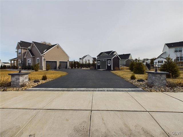 view of street featuring a residential view and concrete driveway