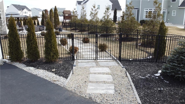 view of gate with a residential view and fence