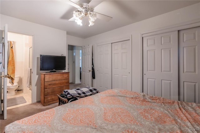 carpeted bedroom with multiple closets, ceiling fan, and connected bathroom