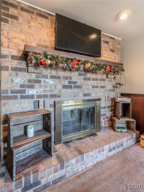 details with carpet flooring and a fireplace