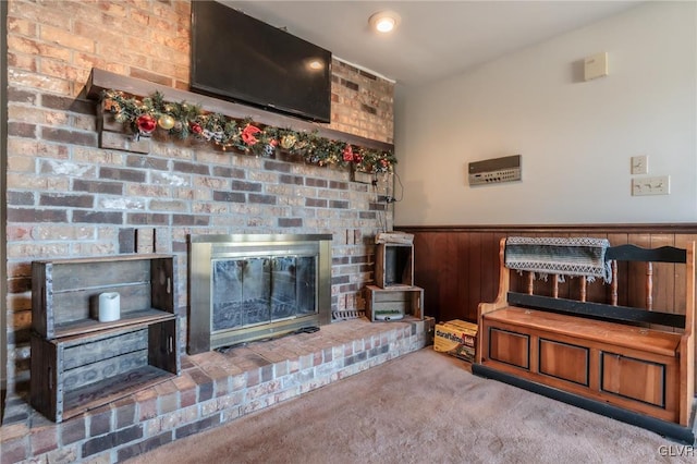 carpeted living room featuring a brick fireplace