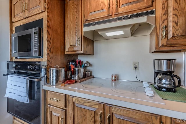 kitchen featuring white electric cooktop and oven