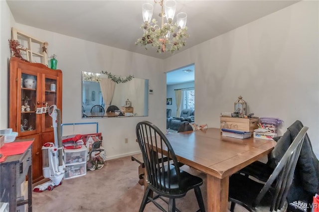 carpeted dining room featuring an inviting chandelier