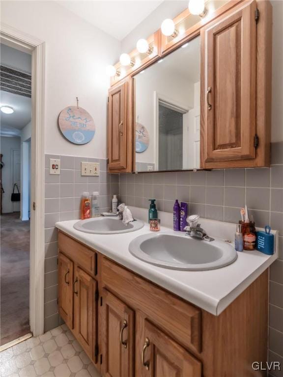 bathroom with vanity and tile walls