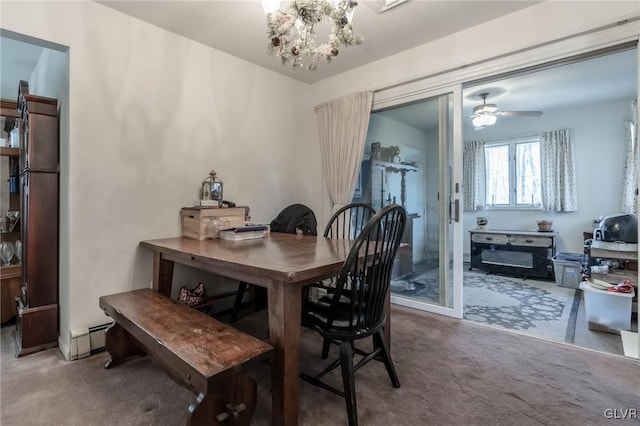 dining room with a baseboard heating unit, carpet flooring, and a notable chandelier