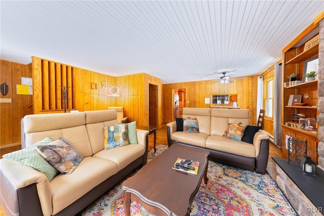 living room featuring wooden walls and wood-type flooring