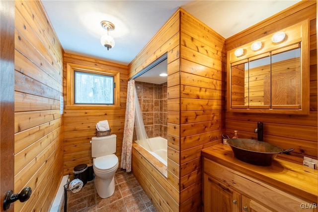 full bathroom featuring shower / tub combo, vanity, toilet, and wood walls