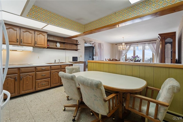 dining room with a notable chandelier and sink