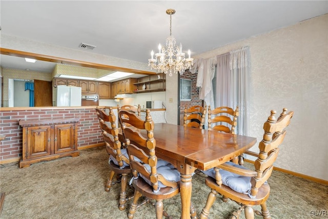 dining room featuring light carpet and a chandelier