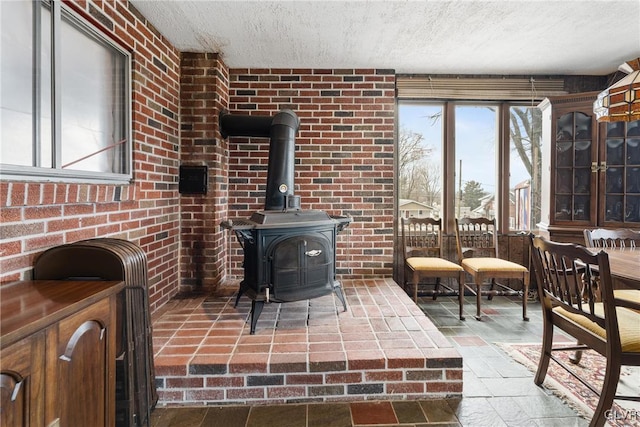 interior space featuring a textured ceiling and a wood stove