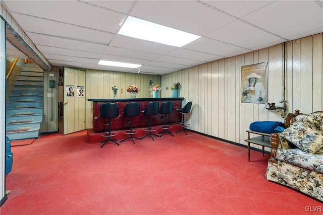 office space featuring a drop ceiling and indoor bar