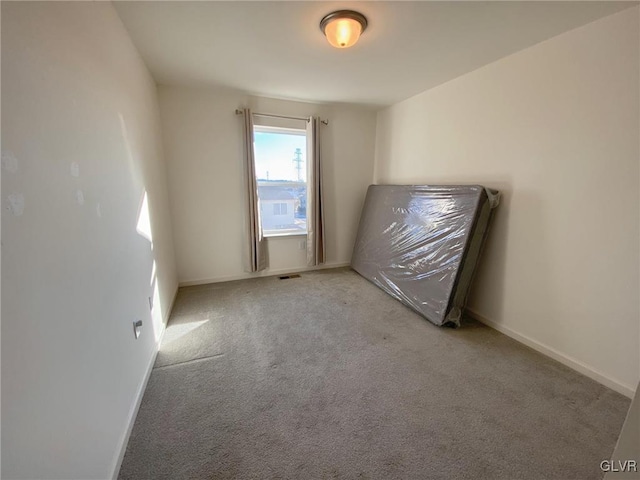 empty room featuring light colored carpet