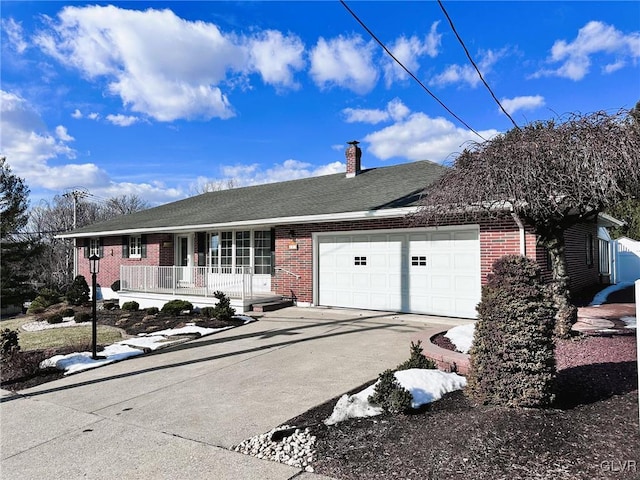 single story home featuring a porch and a garage