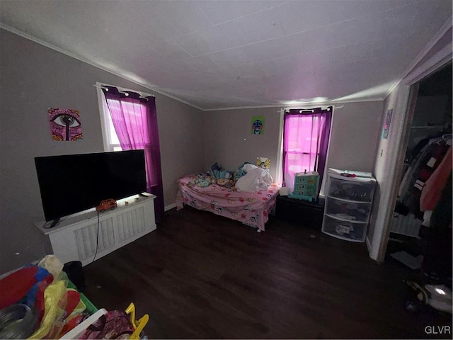 bedroom featuring crown molding and dark hardwood / wood-style flooring