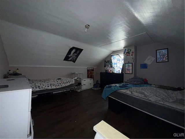 bedroom with dark wood-type flooring and vaulted ceiling