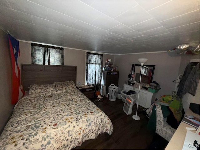 bedroom with dark hardwood / wood-style flooring