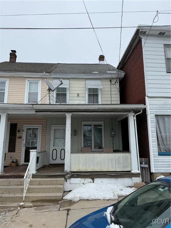 townhome / multi-family property featuring a porch