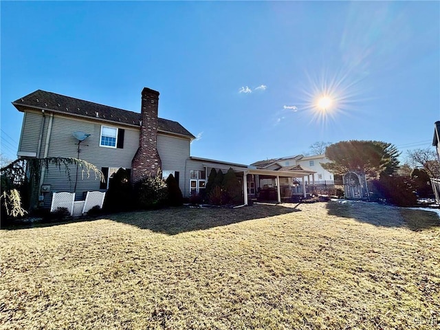 rear view of house with a yard