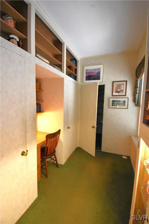 unfurnished office featuring dark colored carpet