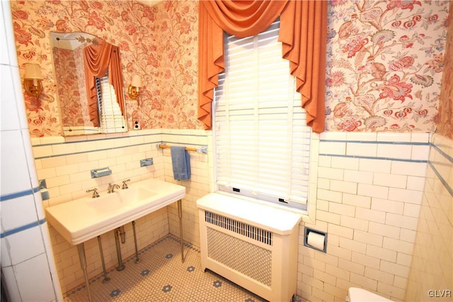 bathroom featuring tile walls and radiator heating unit