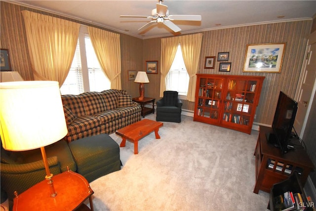 carpeted living room with baseboard heating, ornamental molding, and ceiling fan