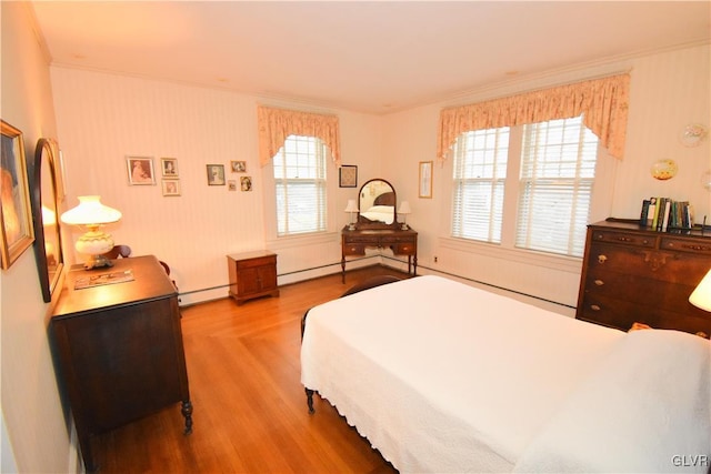 bedroom featuring multiple windows, ornamental molding, hardwood / wood-style flooring, and baseboard heating