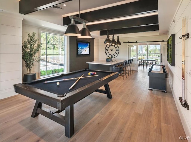 game room with beamed ceiling, billiards, light hardwood / wood-style flooring, and a wealth of natural light