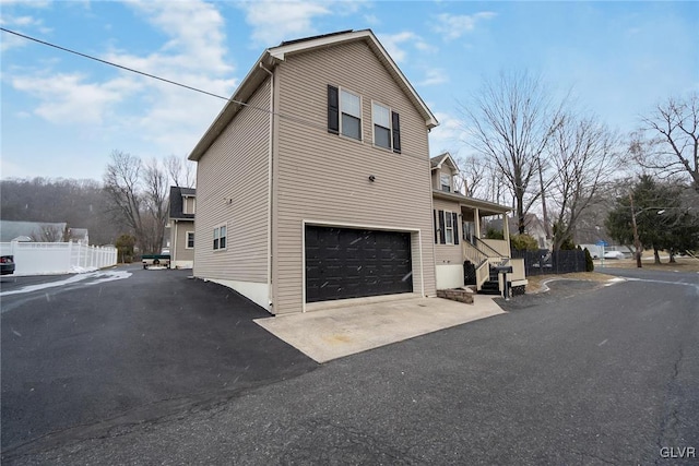 view of side of home featuring a garage