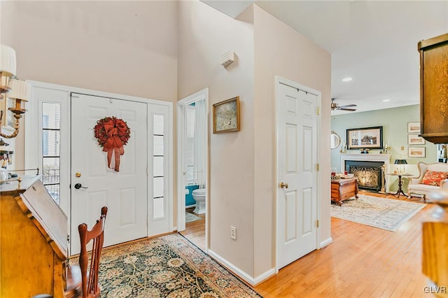 foyer entrance featuring light wood-type flooring and ceiling fan